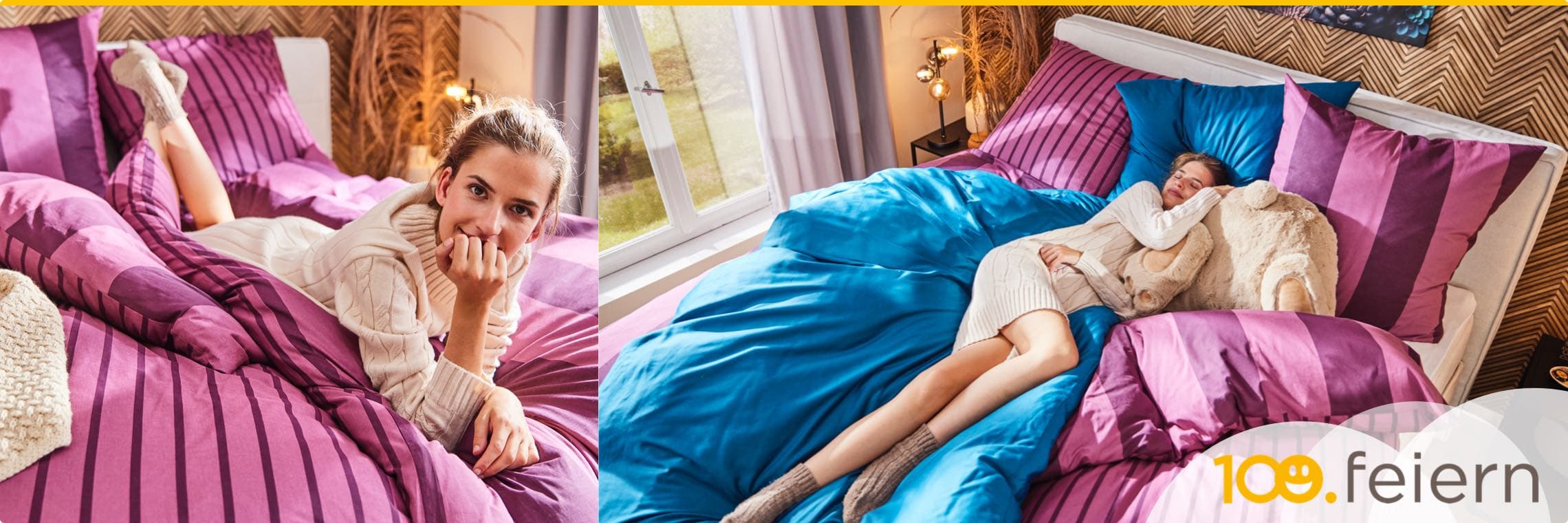 100.feiern – Frau in beigem Strickkleid und Socken liegt auf lila und blauer Bettwäsche in gemütlichem Schlafzimmer.