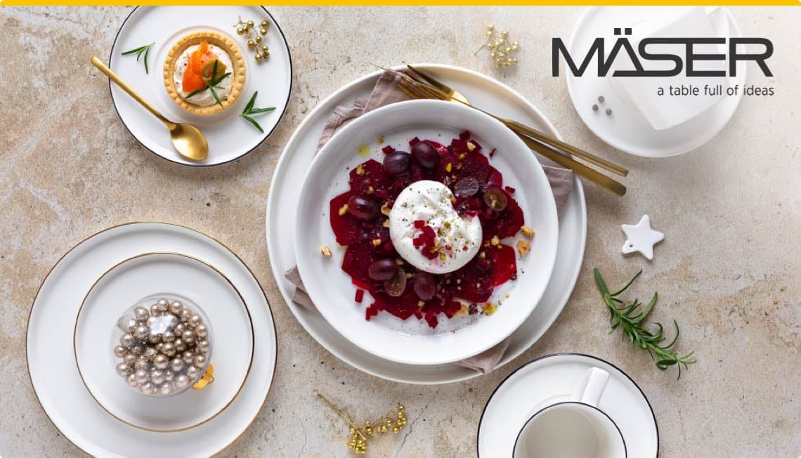 MÄSER – a table full of ideas. Verschiedene Teller mit Vorspeisen und einer Kaffeetasse auf einem Tisch.