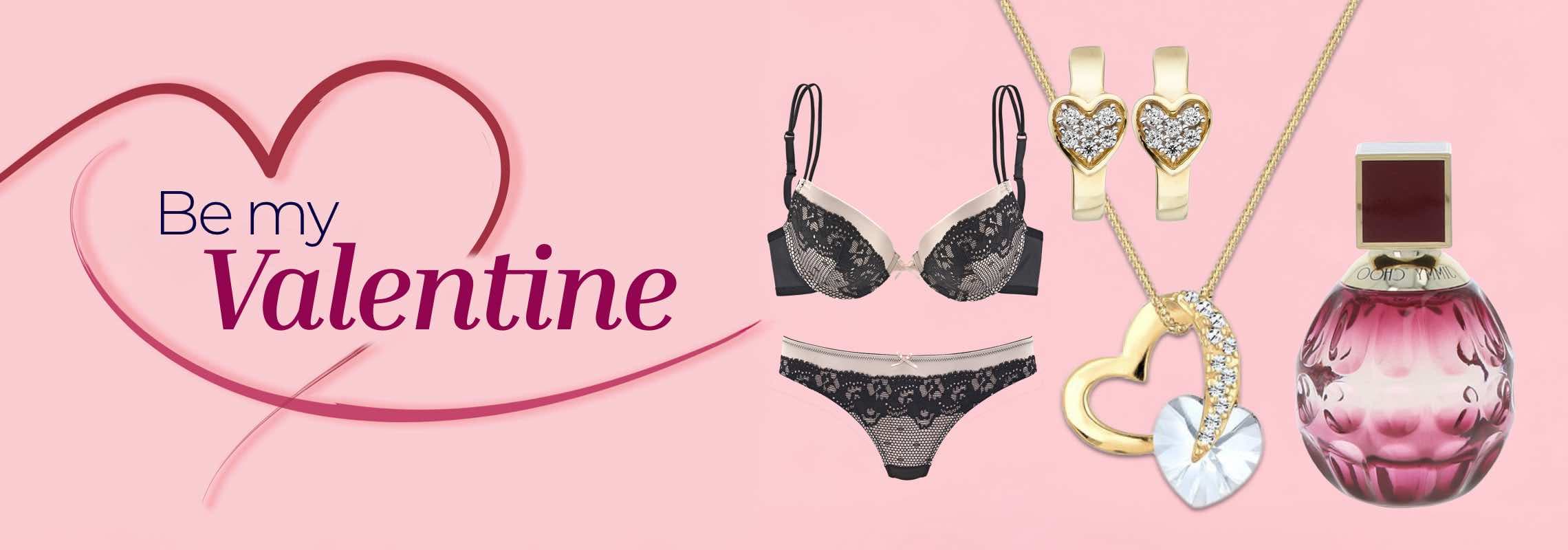 Be my Valentine – Schwarzes Spitzen-BH-Set, goldene Herzohrringe, Herzanhänger und rosa Parfüm auf rosa Hintergrund