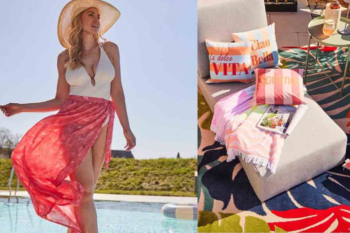 Frau im Badeanzug mit rosa Pareo am Pool, daneben Sonnenliege mit bunten Kissen und Decke auf gemustertem Teppich