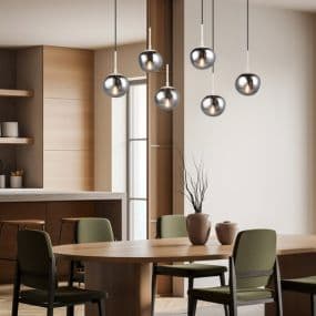 Moderne Küche mit rundem Holztisch und grünen Stühlen, darüber hängende metallische Glas-Kugel-Pendelleuchten