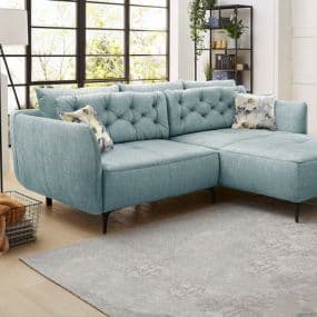 Hellblaues Ecksofa mit Kissen in modernem Wohnzimmer, große Fenster im Hintergrund