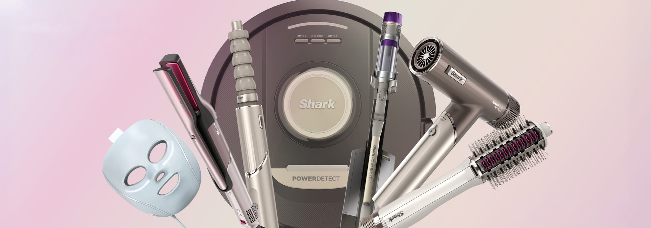 Shark Haarstyling- und Pflegeprodukte auf rosa Hintergrund, darunter Haartrockner, Glätteisen und Lockenstab.