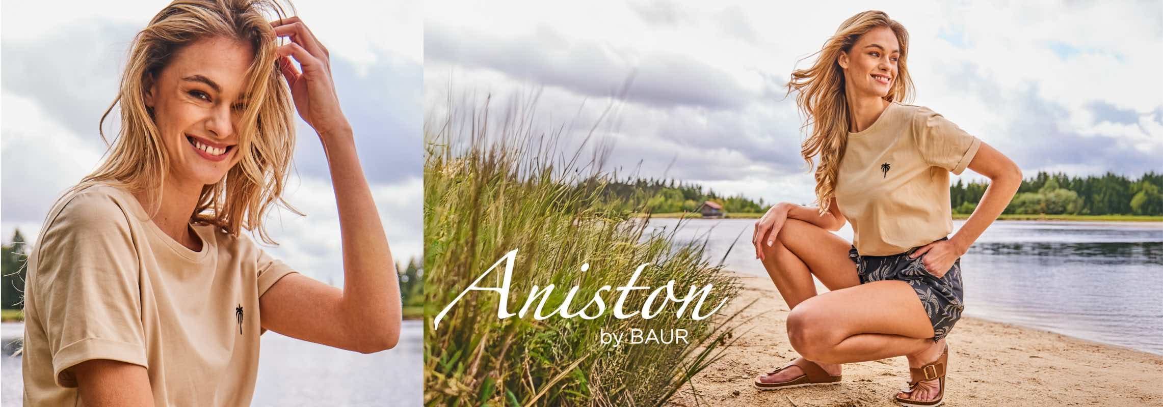 Aniston by BAUR – Frau im beigefarbenen T-Shirt und Shorts sitzt am Seeufer vor Wasser und Wald
