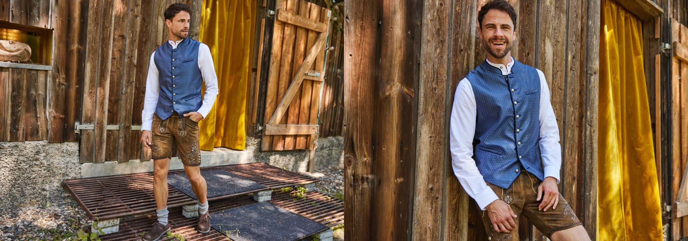 Mann in Trachtenweste und Lederhose steht vor Holzhütte mit gelbem Vorhang