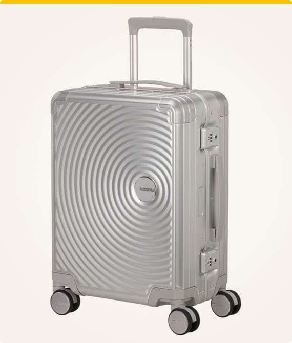 Silberner Rollkoffer mit kreisförmigem Muster, vier Rollen und Teleskopgriff, seitlicher Tragegriff und eingebautes Schloss